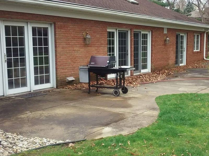 dirty concrete patio before softwash cleaning without pressure washing